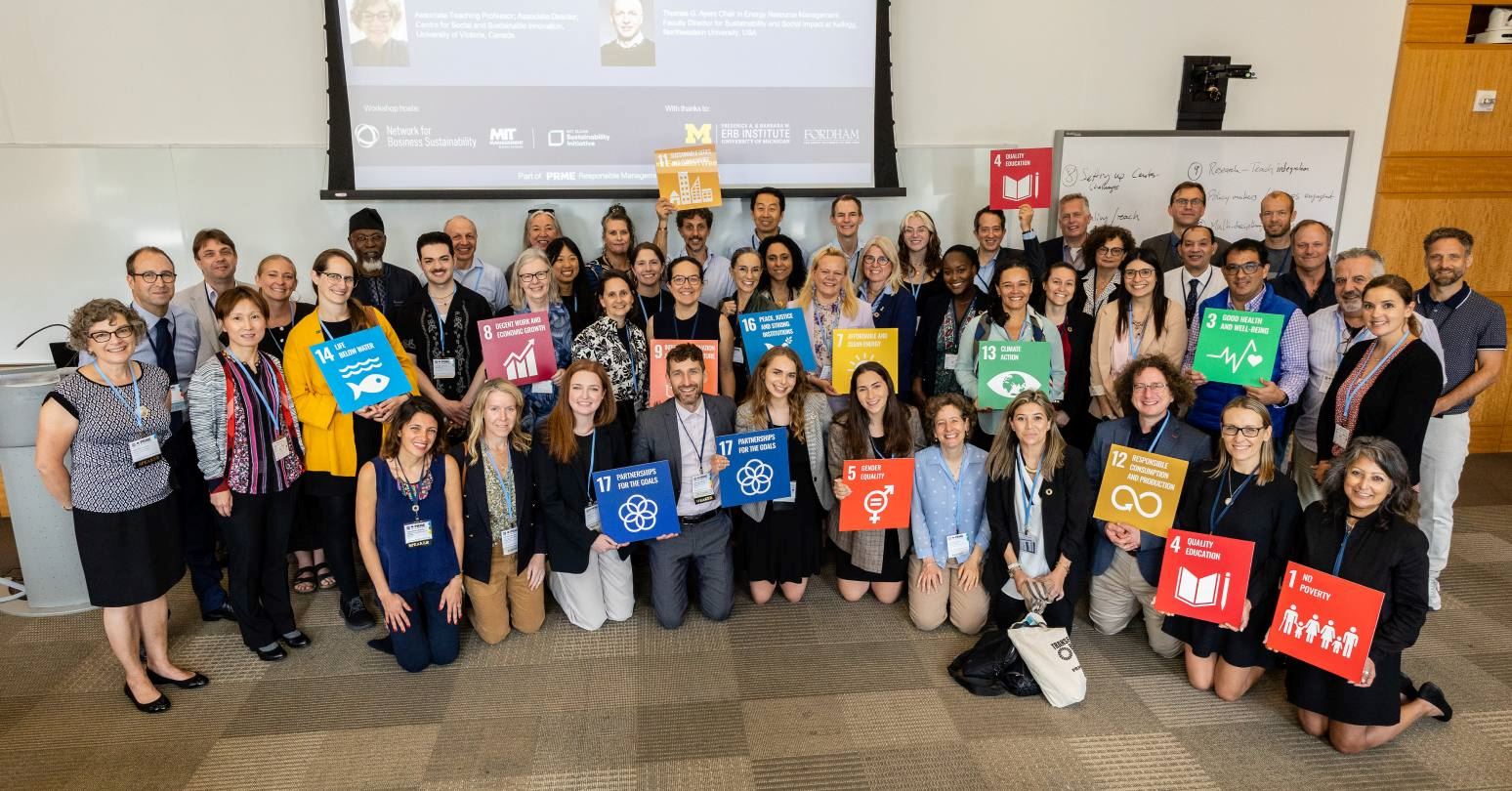 Group of people holding signs of the Sustainable Development Goals