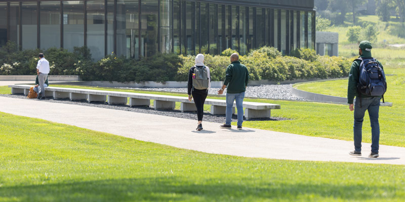 Some Ivey HBA students walking up the path toward the main entrance of the Ivey Business School