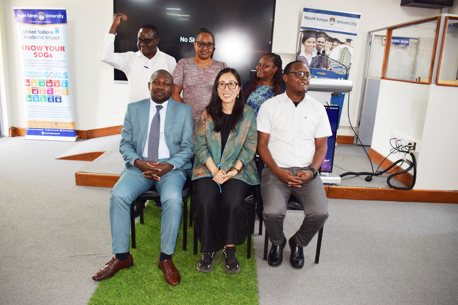 Six professors sitting for a group photo